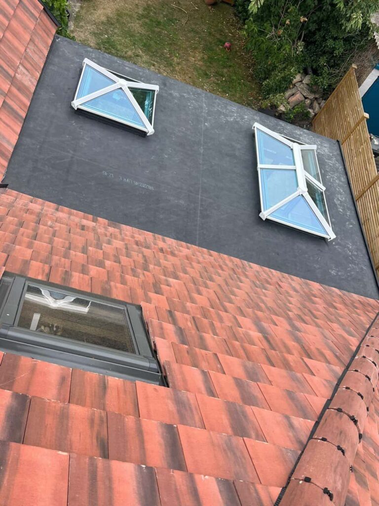 This is a photo taken from the roof ridge looking down a tiled pitched roof on to a flat roof. Works carried out by TRP Roofing Cottingham